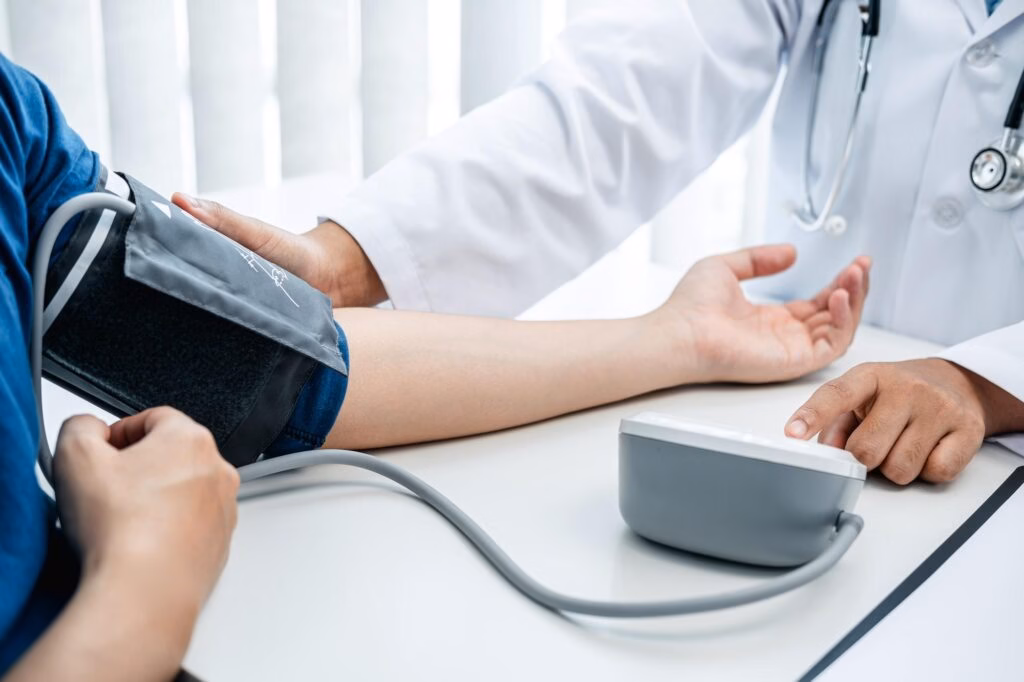 doctor is checking blood pressure using a stethoscope check for the cause of the patient's illness