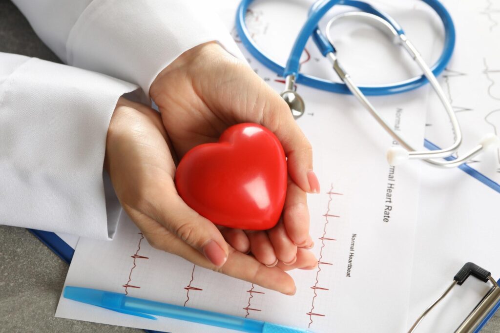 Medical concept with female doctor holding heart